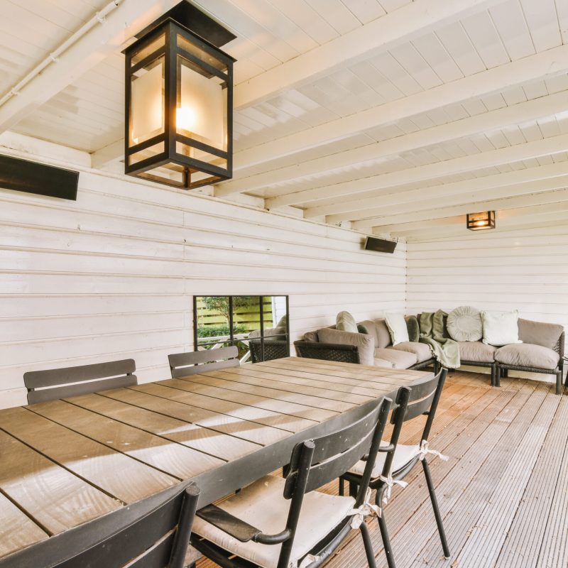 The interior of a cozy recreation area outside a residential building with wooden decoration