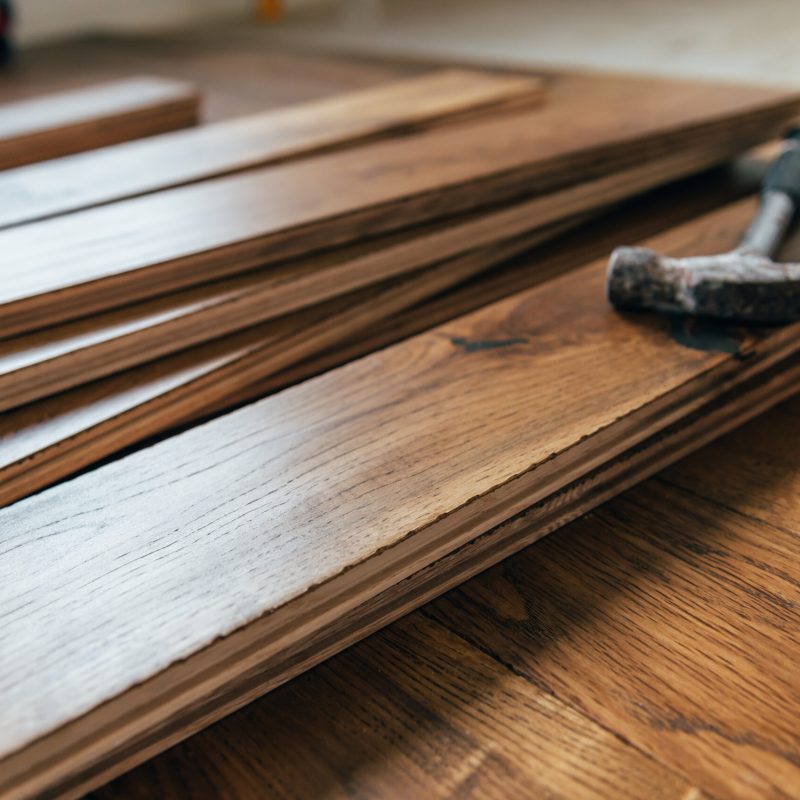 The process of house renovation with changing of the floor from carpets to solid oak wood. Beautiful golden handscraped oiled European oak brushed for added texture and fine definition of wood grain